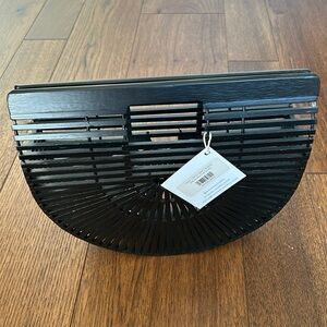 Half circle black bag by Bon Ton Studio.